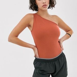 NIKE Yoga Dri-Fit XS One Shoulder Bodysuit in Rust Orange